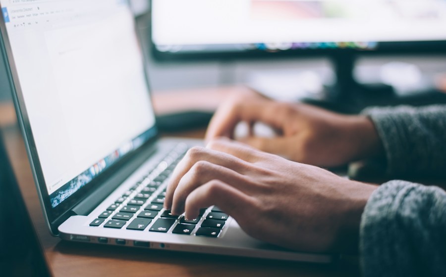 Person completing a loan application on a laptop